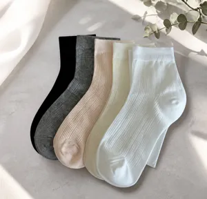 Detail of five-pair ribbed knit cotton flower socks in black, grey, pink, cream, and white