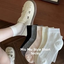 Detail of five-pair ribbed knit cotton flower socks in black, grey, pink, cream, and white