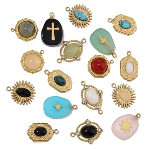 Detailed close-up of DIY gold titanium steel charms with natural stones and onyx on white