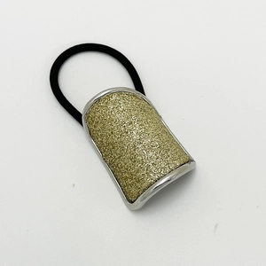 Detail of high-elastic ponytail holder with sparkling gold glitter rectangular ornament