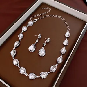 Elegant silver teardrop crystal necklace and earring set with shimmering white zircons