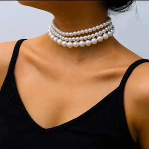 Bohemian multilayered pearl choker necklace with four tiers of elegant white pearls