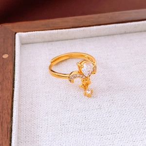 Detail of 24K gold plated flower ring with pear-cut stone and vine micro-pave