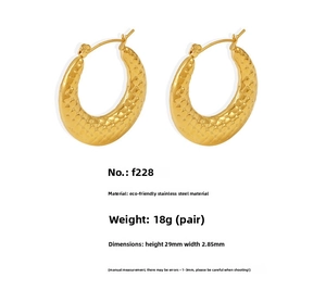Detail of 18k gold plated U-shaped stainless steel hoop earrings with engraved grid texture