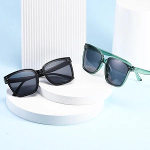 Modern oversized square sunglasses in black and transparent green with silver rivets