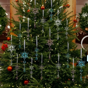 Close-up of clear, blue, and purple acrylic crystal snowflake and teardrop ornaments