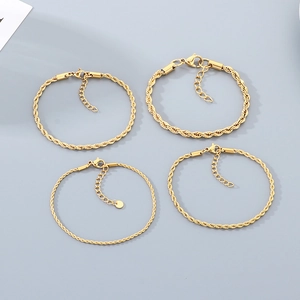 Detail view of four gold-plated stainless steel twist rope bracelets in various thicknesses