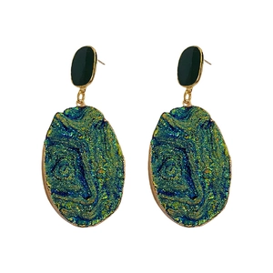 Blue geometric wrinkled heart earrings with irregular texture and gold trim on white background
