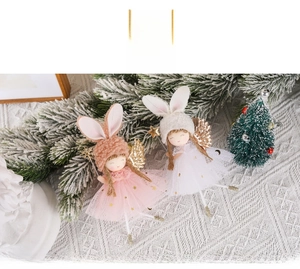 Detail of plush Christmas angel ornaments with sequin skirts and glitter wings