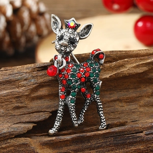 Elegant deer brooch with colorful rhinestones on rustic wood with pine cones