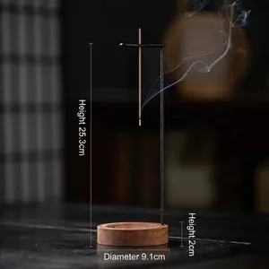 Zen style walnut wood and black metal hanging incense burner with elegant rising smoke