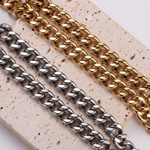 Polished punk Cuban link chain in gold and silver finish on stone base
