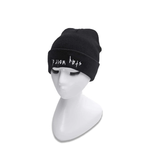 Classic black knitted beanie with white Stay Weird embroidery on the folded cuff