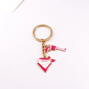 Pink revolver and star pattern bandana charms on a gold alloy western keychain