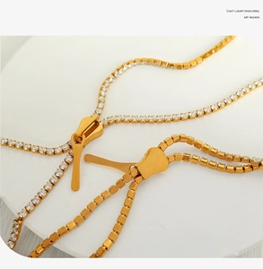 Close-up of golden zipper pendant necklace inlaid with brilliant white cubic zirconia