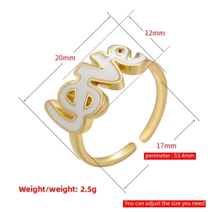 Detail view showing golden LOVE letter ring dimensions and white enamel surface