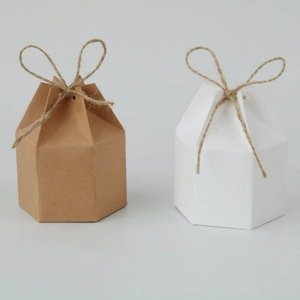 Hexagonal kraft paper gift boxes in white and natural brown with twine bow accents