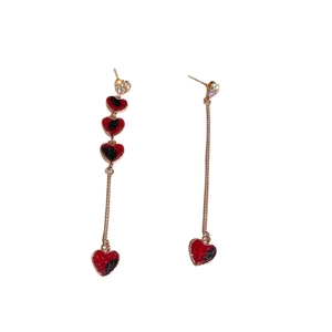 Asymmetrical heart drop earrings with red and black velvet texture and rose gold accents