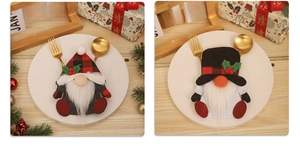 Close-up of gnome and snowman cutlery holders on a festive Christmas table setting