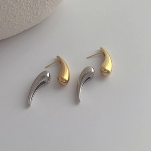 Polished silver and gold teardrop earrings in minimalist geometric metal style