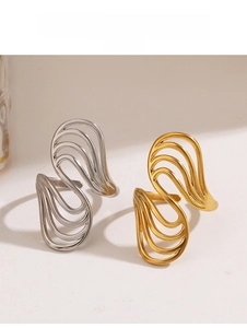 Detail of minimalist wavy cutout open rings in polished gold and silver finishes