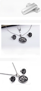 Close-up of vintage tree of life stainless steel necklace and stud earrings set
