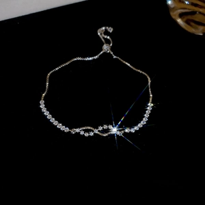 Detail of adjustable silver bolo bracelet featuring cubic zirconia and sleek feather design