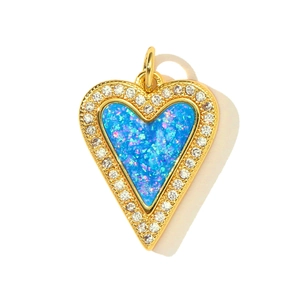 Detailed view of heart-shaped opal pendant with gold frame and sparkling zircons