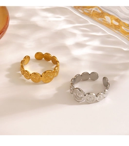 Detail of adjustable geometric sunburst rings in gold and silver finish with wave shadows