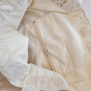 Detail view of the embroidered fabric interior with a secure zipper pocket on this tote