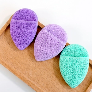 Thickened konjac facial sponges in teardrop shape on a wooden tray for deep cleansing