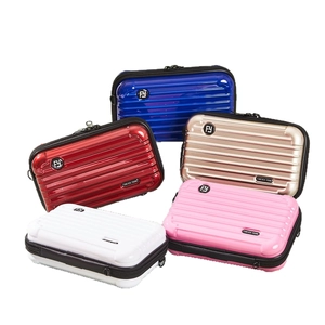 Five assorted mini hardshell crossbody cosmetic cases in glossy red, blue, and gold