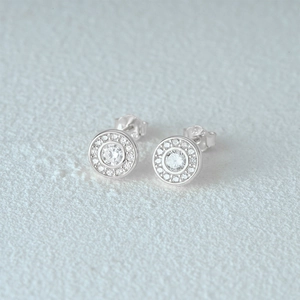 Macro shot of 925 sterling silver halo stud earring with sparkling cubic zirconia stone