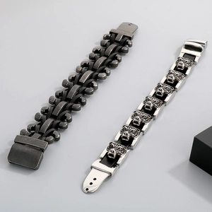 Macro shot of men's leather bracelets with detailed stainless steel tiger head carvings