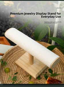 Detail view of T-bar jewelry display stand with wooden base and white fabric bar
