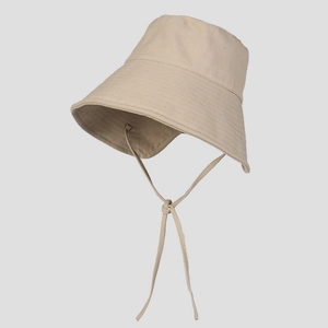 Detail of beige sun hat with wide brim, adjustable chin strap, and premium twill texture