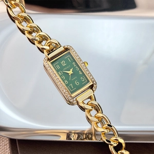 Elegant gold chain watch for women featuring a green square dial and diamond-set bezel
