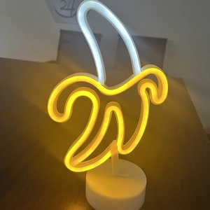 Detailed view of banana-shaped LED neon light with white round base and glowing tubes