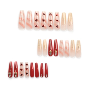 Deep red maple leaf press-on nails with glitter sequins and rhinestone accents in coffin shape