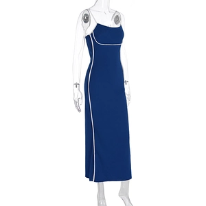 Detail view of navy blue bodycon dress featuring white contrast piping and side slit detail