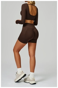 Detail of ribbed backless long sleeve yoga top and high waist shorts in dark brown