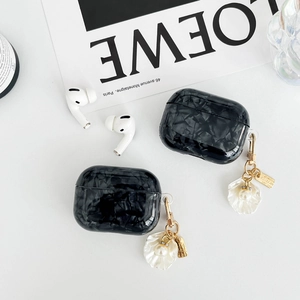 Glossy black marble texture AirPods Pro case with elegant gold shell and pearl keychain