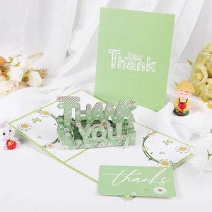 Detail of 3D pop-up thank you card with daisy floral design and green paper texture