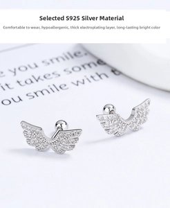 Macro view of S925 sterling silver wing earrings with CZ diamonds and screw-back ball