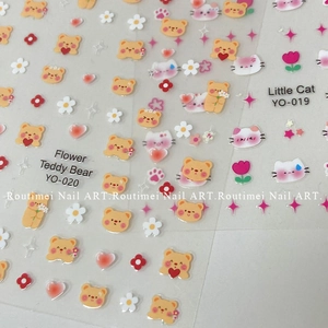 Detailed view of self-adhesive nail stickers featuring teddy bear and floral patterns