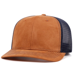 Detail of a brown suede peak and dark blue mesh panels on a two-tone trucker hat