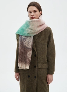 Detail of colorful jacquard ginkgo leaf scarf with tassels on brown wool coat