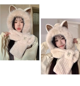 Detail of plush beige cat ear hat with scarf showing soft faux fur texture and MO label
