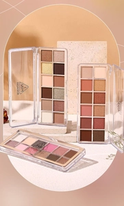 Detailed view of three MINSHSEE multi-color eyeshadow palettes on textured stone props