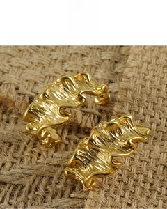 Detailed macro view of 18K gold-plated stainless steel earrings with wavy wrinkle texture